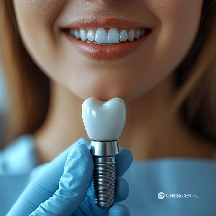 a dental assistant is holding a dental implant